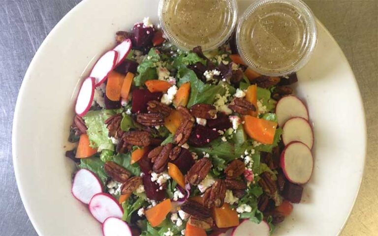 pecan salad with dressing and radishes at ozone pizza pub pensacola