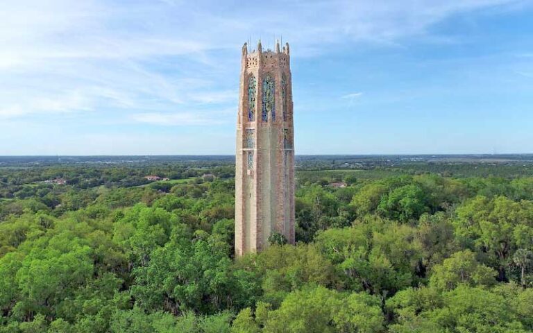 pink stone tower rising above tree line at bok tower gardens lake wales