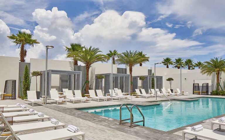 pool area with palm trees and loungers at the daytona autograph collection hotel