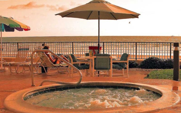 pool deck with jacuzzi at twilight at tropic shores resort daytona beach