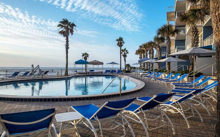 pool deck with loungers and hotel at the shores resort spa daytona beach