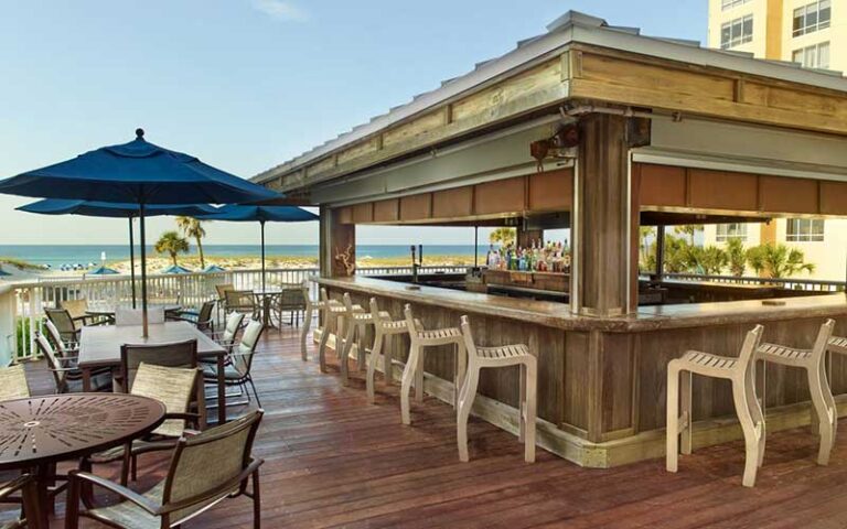 poolside tiki bar with beach in background at springhill suites pensacola beach