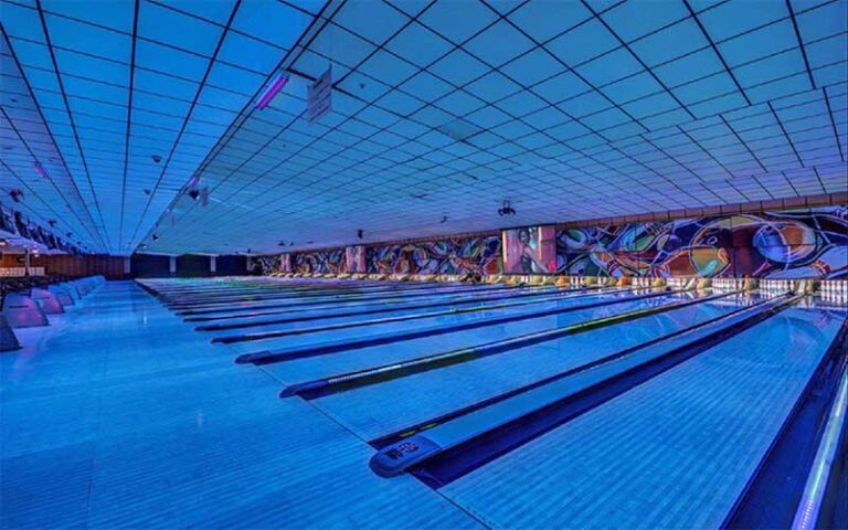 rows of bowling lanes with neon lighting at incredibowl entertainment winter haven