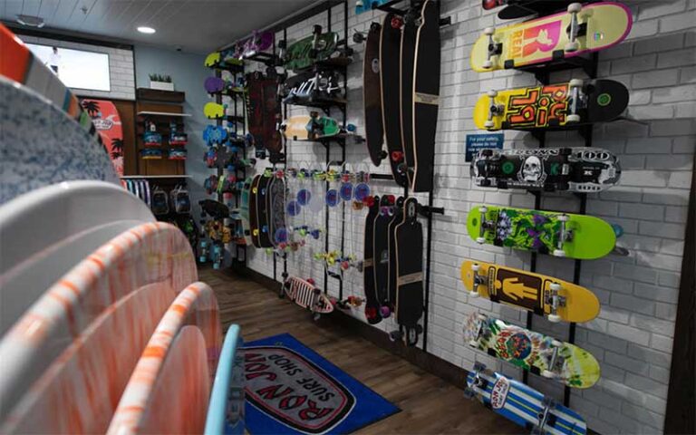 skimboards and skateboards on racks in store at ron jon surf shop pensacola beach