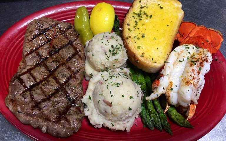 steak and lobster tail with sides at peg leg petes pensacola