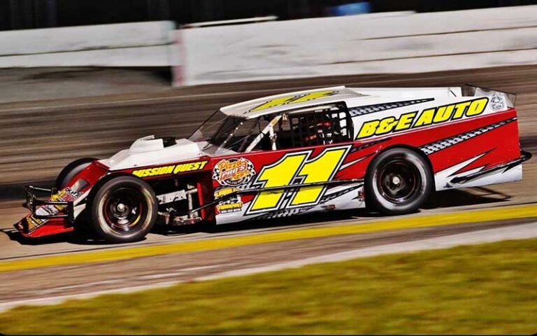 stock car with eleven racing along track at auburndale speedway winter haven