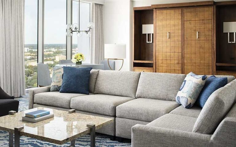 suite with sectional sofa and floor to ceiling windows at hyatt regency hotel orlando