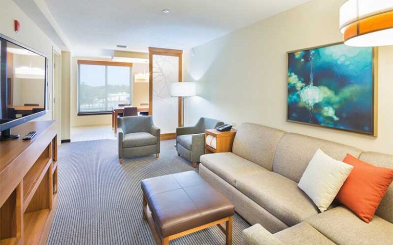 suite with sofa and table at hyatt place pensacola airport