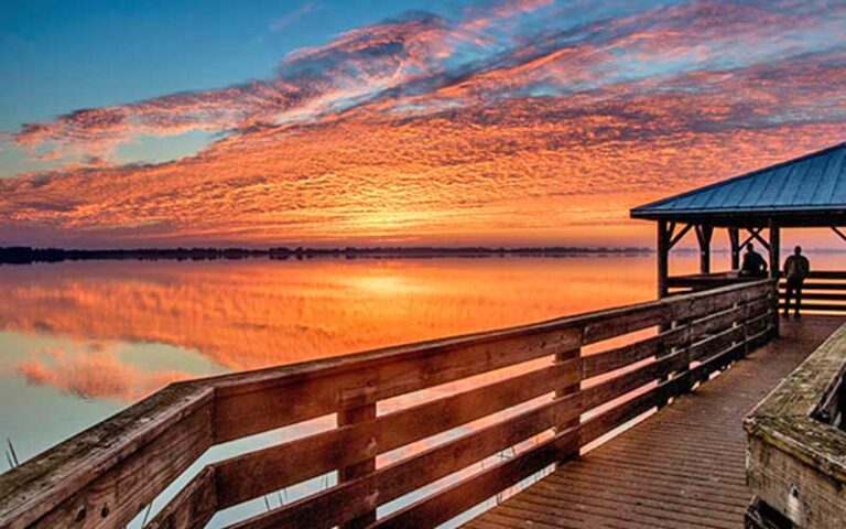 sunset over lake from boardwalk with pavilion at circle b bar reserve lakeland