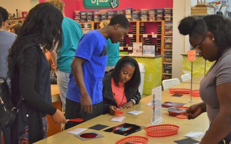 teens working on project at table at pensacola mess hall