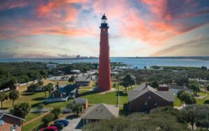 twilight view of red lighthouse with outer buildings at ponce de leon inlet lighthouse museum daytona beach