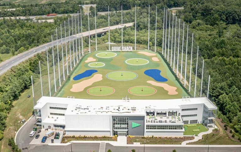 aerial view above driving range facility surrounded by trees at drive shack west palm beach