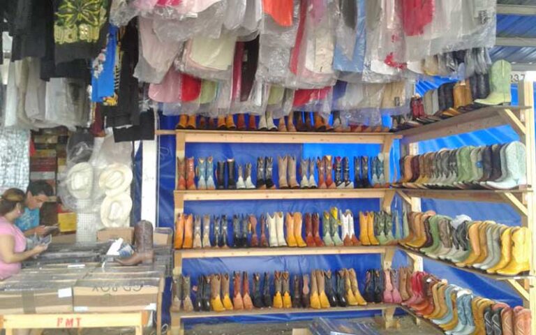 booth area with boots and clothing at tallahassee flea market