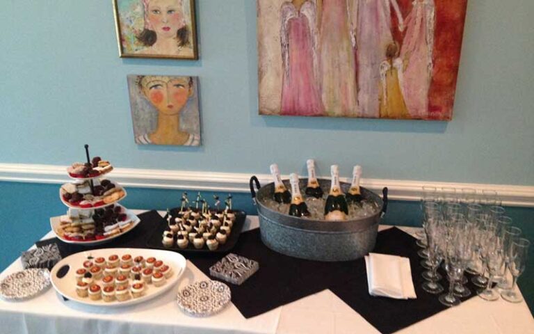 catering table with champagne and wall art at kool beanz cafe tallahassee