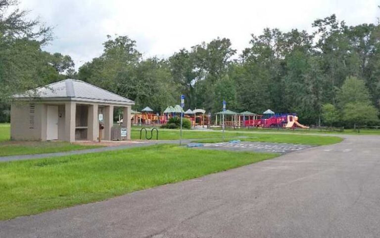 colorful kids playground area with restroom facility along paved path at tallahassee st marks historic railroad state trail