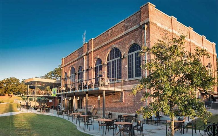 corner exterior of brick two story restaurant with outdoor decks at the edison tallahassee