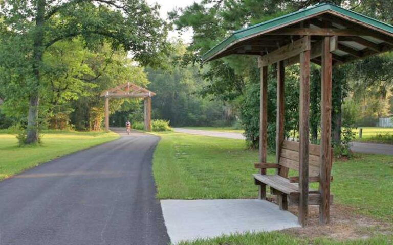 curving trail with bikers and rest stops at tallahassee st marks historic railroad state trail