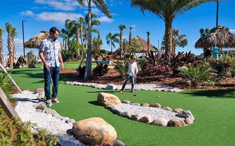 dad and son playing mini golf at camp margaritaville auburndale