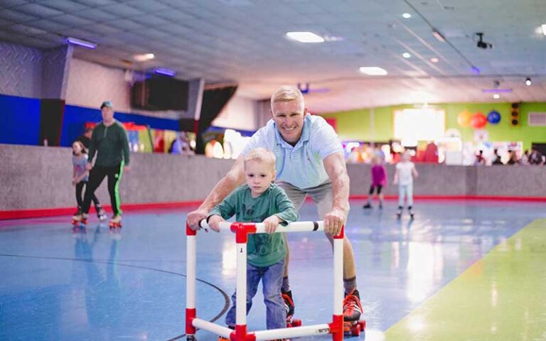 dad and son skating with trainer at skate world tallahassee