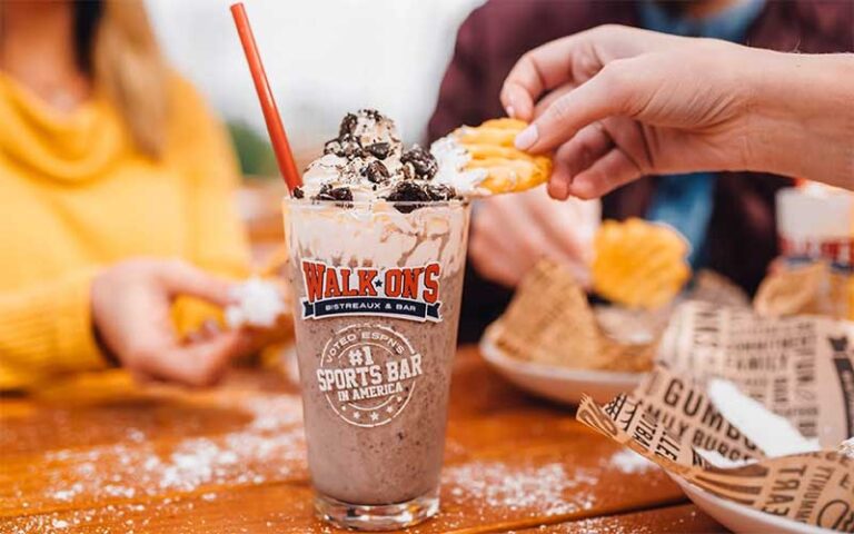 diners sharing fries with chocolate shake in branded glass at walk ons sports bistreaux lakeland