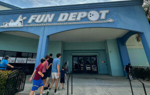 entrance with sign and boys at fun depot lake worth west palm beach