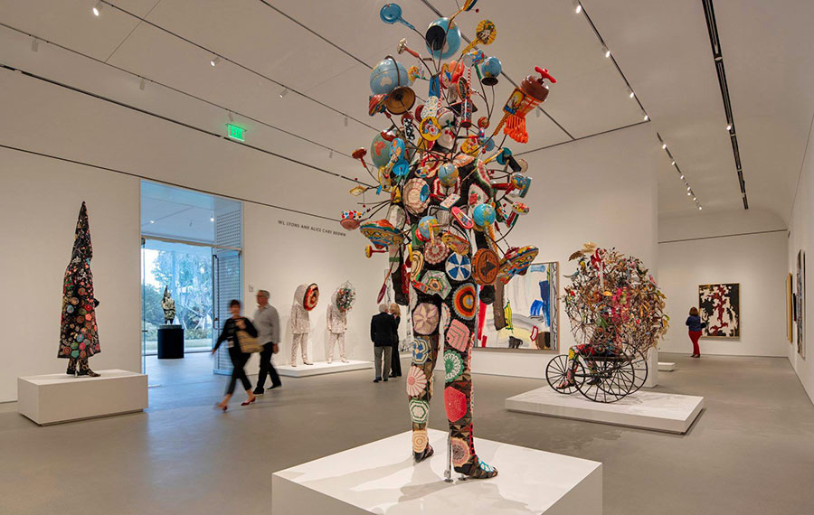 exhibit gallery with sculpted modern figures and patrons at norton museum of art west palm beach
