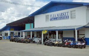 exterior of warehouse with blue and sign at tallahassee flea market