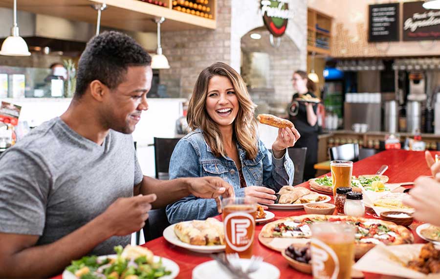 family diners eating pizza in bistro flippers pizzeria st pete