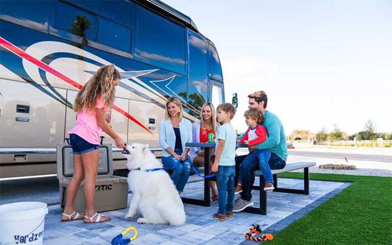 family with dog next to rv at camp margaritaville auburndale