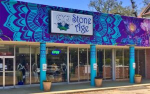 front exterior of store with murals and sign at stone age tallahassee