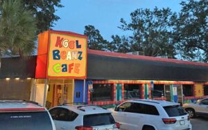 front exterior at night with sign and parking at kool beanz cafe tallahassee