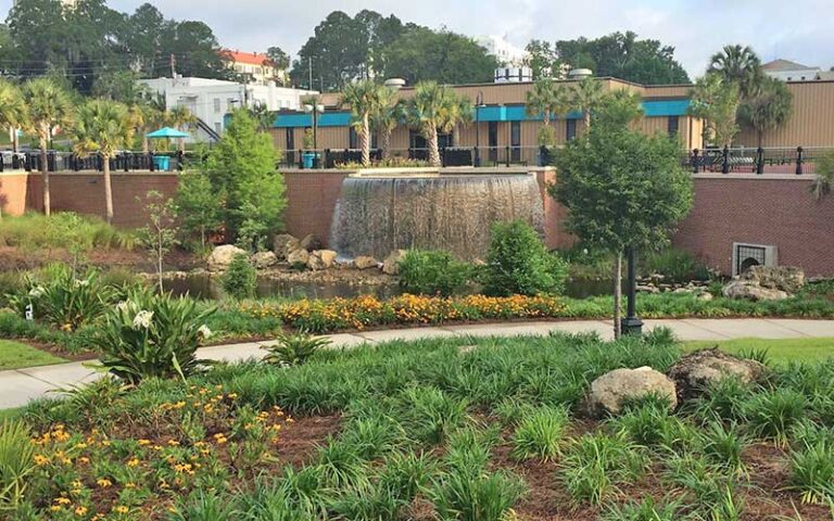 garden wall with waterfall fountain and flowers at cascades park tallahassee