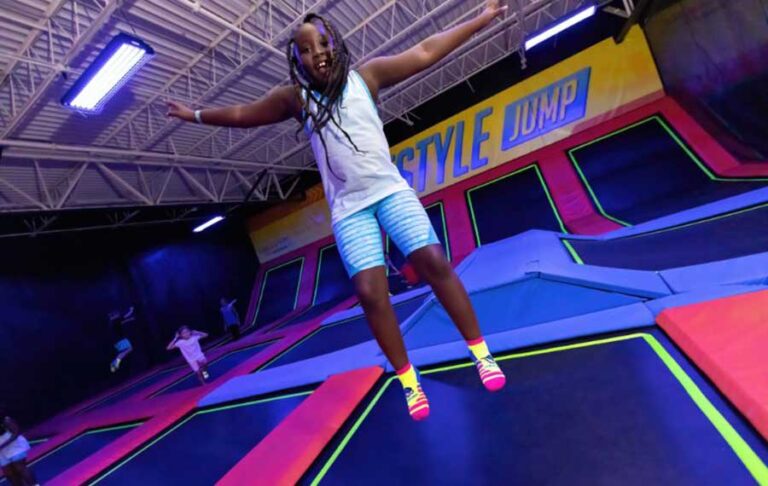 girl bouncing high in trampoline area at urban air trampoline adventure park