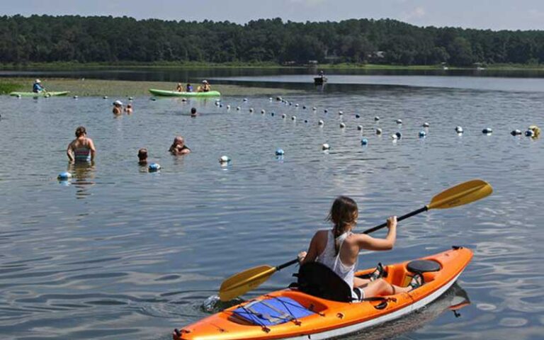 kayaker and swimmers in lake at alfred b maclay gardens state park tallahassee