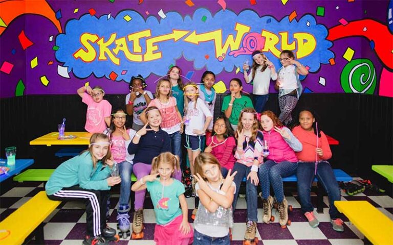 kids posing in party room with glowsticks at skate world tallahassee