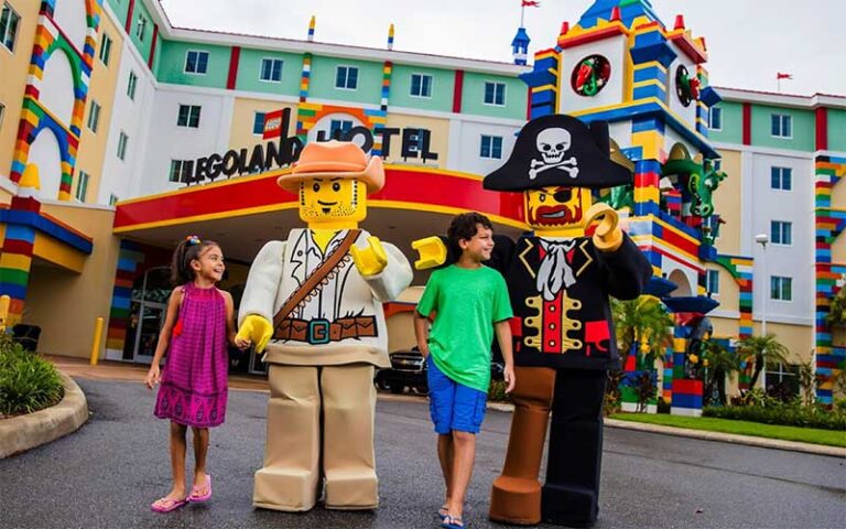 kids walking with lego costumed characters in front of hotel at legoland hotel winter haven