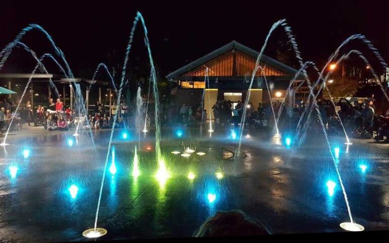 night view of lighted splashpad with crowd at cascades park tallahassee