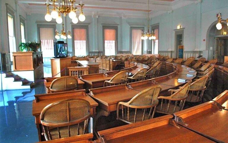 old senate area with rounded desks and cane chairs at florida historic capitol museum tallahassee