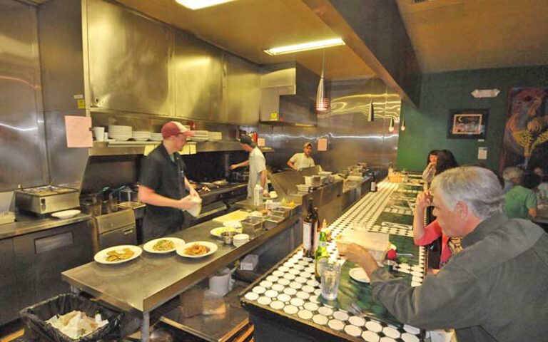 open kitchen with chefs preparing entrees at kool beanz cafe tallahassee