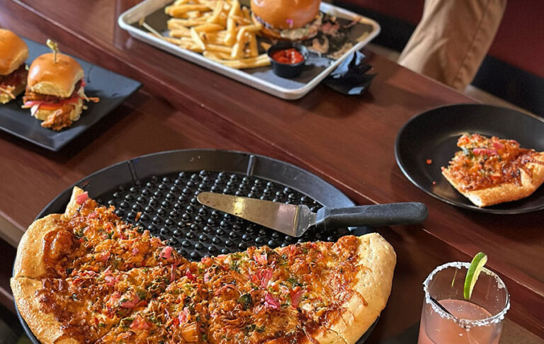 pizza burgers and beer served on table bowling area at fun depot lake worth west palm beach