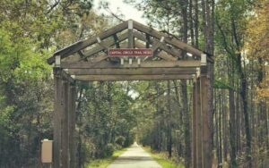 railroad archway with capital circle trailhead sign at tallahassee st marks historic railroad state trail