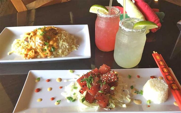 seafood entrees with cocktails on table at wahoo seafood grill tallahassee