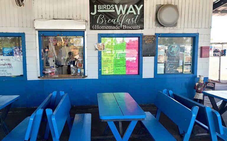 snack bar windows with blue picnic tables at tallahassee flea market