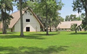 spanish colonial style buildings with expanse of green grass at mission san luis tallahassee