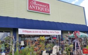 store front with signs and entrance at shermans antiques winter haven