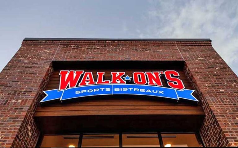 view from below of brick facade with sign at walk ons sports bistreaux lakeland