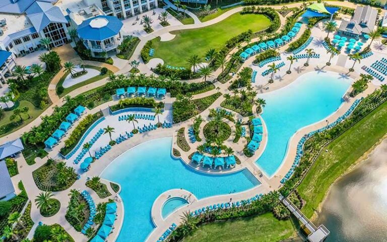 aerial view looking down at large multi pool area with clubhouse at margaritaville resort orlando kissimmee