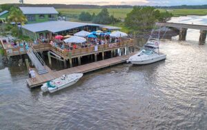 aerial view of dining patio on dock with boats and river at down under restaurant fernandina beach amelia island
