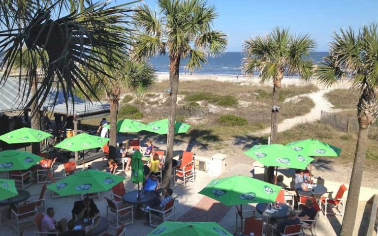 aerial view of patio seating with path to beach and palms at sliders seaside grill fernandina beach amelia island