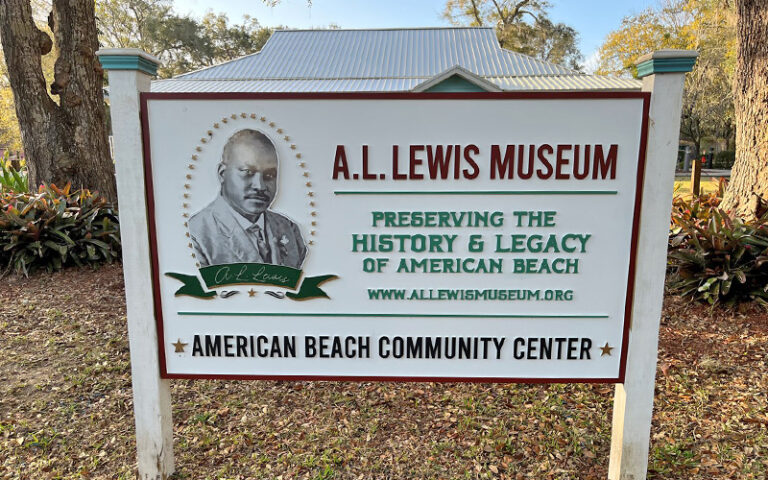 al lewis museum sign with trees at american beach amelia island